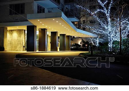 USA, Apartment building driveway at night, Decorated with white lights in trees for Christmas View Large Photo Image Stock Photo - USA, Apartment building driveway at night, Decorated with white lights in trees for Christmas. Fotosearch