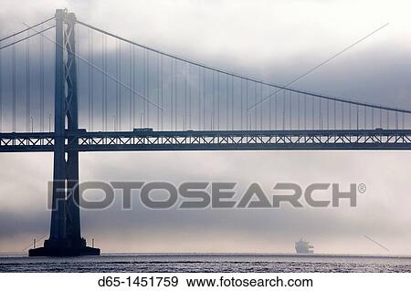 Stock Photo - USA, California, San Francisco, Embarcadero, Bay Bridge in fog. Fotosearch