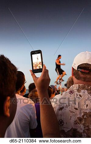 USA, Florida, Florida Keys, Key West, Mallory Square, daily sunset party, photographing the juggler, NR. View Large Photo Image Picture - USA, Florida, Florida Keys, Key West, Mallory Square, daily sunset party, photographing the juggler, NR.. Fotosearch