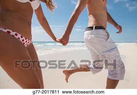 Usa. Florida. Miami Beach. Couple running on a beach. View Large Photo Image Stock Image - Usa. Florida. Miami Beach. Couple running on a beach.. Fotosearch