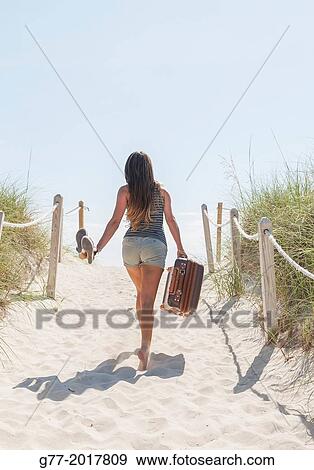 Usa. Florida. Miami Beach. Woman with nag going to the beach. View Large Photo Image Stock Photo - Usa. Florida. Miami Beach. Woman with nag going to the beach.. Fotosearch