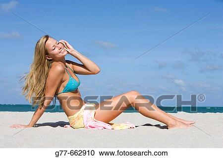 Stock Image - Usa. Florida. Miami. Key Biscayne. Woman on the beach of Crandon Beach.. Fotosearch