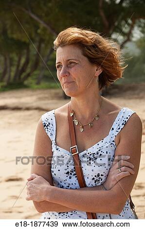 USA, Hawaii, Oahu, North Shore Woman standing on the beach with her arms folded View Large Photo Image Stock Photo - USA, Hawaii, Oahu, North Shore Woman standing on the beach with her arms folded. Fotosearch
