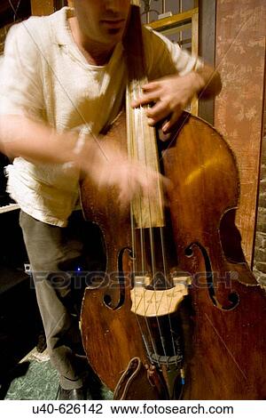 USA. New York City. Jazz club, upright bass player strumming. View Large Photo Image Stock Image - USA. New York City. Jazz club, upright bass player strumming.. Fotosearch