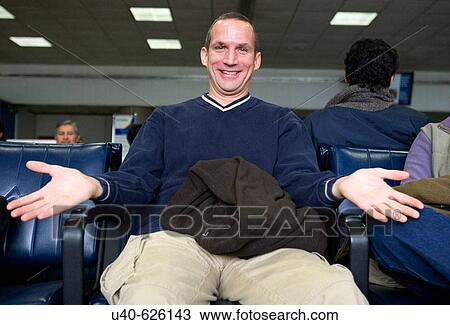 Stock Image - USA. New York City, JFK (John F. Kennedy Airport). Smiling man with open arms.. Fotosearch