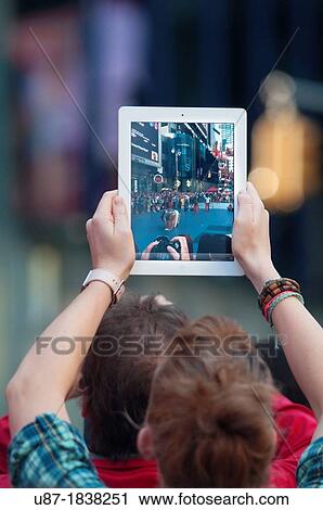 Usa, New York City, Manhattan, Times Square, Man Using iPad for Taking Photographs View Large Photo Image Stock Image - Usa, New York City, Manhattan, Times Square, Man Using iPad for Taking Photographs. Fotosearch