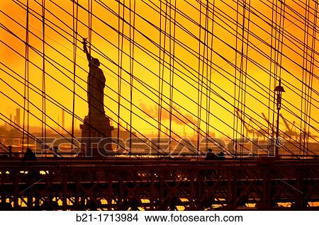 Picture - USA, New York, statue of the Liberty behind the Brooklyn bridge.. Fotosearch