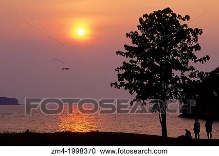 Stock Image - USA, OHIO, LAKE ERIE, SOUTH BASS ISLAND STATE PARK, SUNSET.. Fotosearch