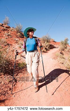 USA, Utah, woman hiking at Escalante at Escalante Petrified Forest State Park to enjoy the petrified wood, views of the Grand Staircase and Colorado Plateau, and local vegetation such as pinon pine and Utah juniper MR View Large Photo Image Stock Image - USA, Utah, woman hiking at Escalante at Escalante Petrified Forest State Park to enjoy the petrified wood, views of the Grand Staircase and Colorado Plateau, and local vegetation such as pinon pine and Utah juniper MR. Fotosearch