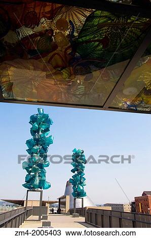 Stock Image - USA, WASHINGTON STATE, TACOMA, MUSEUM OF GLASS, CHIHULY BRIDGE OF GLASS, GLASS SCULPTURE, TUNNEL, JANE'S HOT SHOP TOWER IN BACKGROUND.. Fotosearch