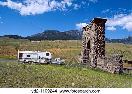 USA Wyoming Yellowstone National Park north entrance Truck with a camper trailer cruises View Large Photo Image Picture - USA Wyoming Yellowstone National Park north entrance Truck with a camper trailer cruises. Fotosearch