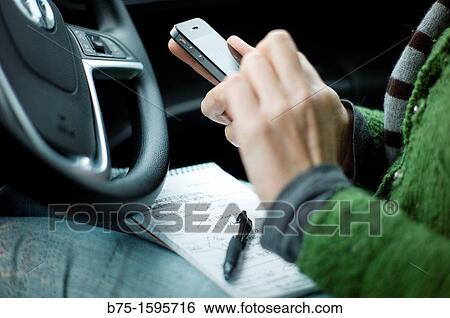 Using smartphone in car View Large Photo Image Stock Photograph - Using smartphone in car. Fotosearch