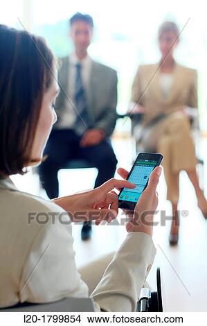 Using smartphone View Large Photo Image Picture - Using smartphone. Fotosearch