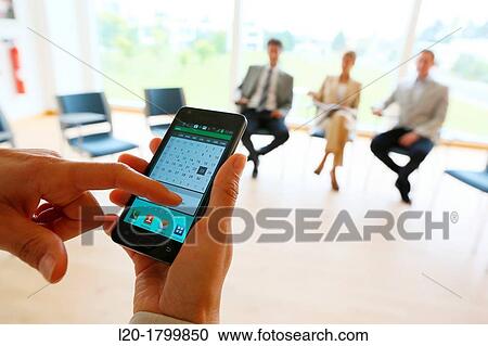 Stock Image - Using smartphone. Fotosearch