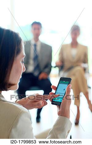 Stock Image - Using smartphone. Fotosearch