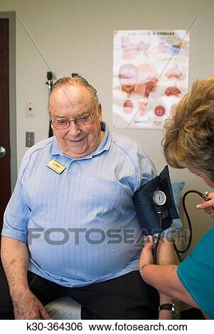 Using sphygmomanometer on medical check View Large Photo Image Stock Photograph - Using sphygmomanometer on medical check. Fotosearch