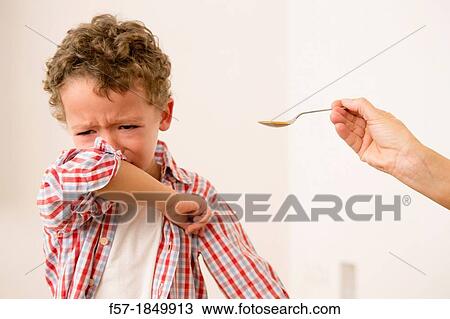Uunhappy four year old being given medicine View Large Photo Image Stock Image - Uunhappy four year old being given medicine. Fotosearch