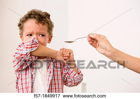 Uunhappy four year old being given medicine View Large Photo Image Stock Photo - Uunhappy four year old being given medicine. Fotosearch