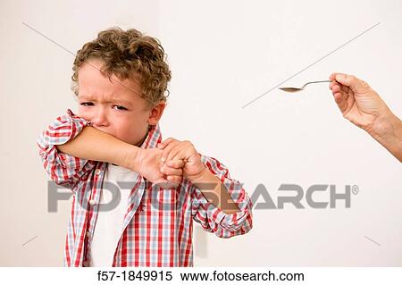 Uunhappy four year old being given medicine View Large Photo Image Stock Photography - Uunhappy four year old being given medicine. Fotosearch