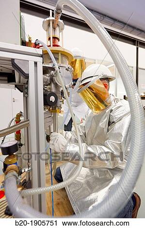 Stock Image - Vacuum Levitation Equipment Assisted by an induction furnace, the vacuum levitation equipment 100-1000 g comprises a crucible, coil and mould manufactured in Cu and refrigerated by water. Fotosearch