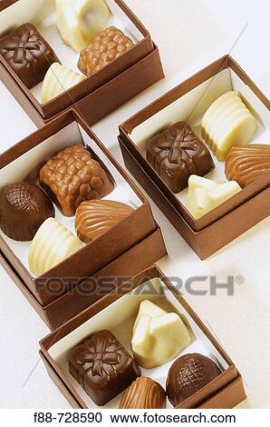 Variety of chocolates placed in small brown boxes, dessert, gifts, food View Large Photo Image Stock Image - Variety of chocolates placed in small brown boxes, dessert, gifts, food. Fotosearch