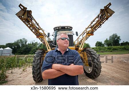 Vegetable producer standing in front of self propelled spray rig, Charles County Maryland USA View Large Photo Image Stock Photography - Vegetable producer standing in front of self propelled spray rig, Charles County Maryland USA. Fotosearch