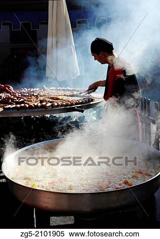 vegetables boiling in large pan and man preparing meats on giant barbecue in the annual All Saints Market in Concentaina, Alicante province, Spain. View Large Photo Image Stock Photography - vegetables boiling in large pan and man preparing meats on giant barbecue in the annual All Saints Market in Concentaina, Alicante province, Spain.. Fotosearch