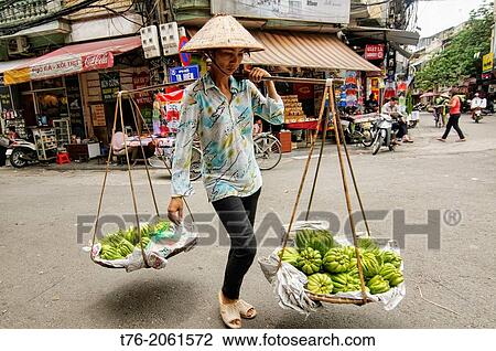 vendor and her balance pole and baskets in Hanoi, Vietnam. View Large Photo Image Stock Image - vendor and her balance pole and baskets in Hanoi, Vietnam.. Fotosearch