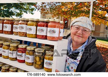Vendor of home made preserves/pickles and relishes sells her product directly to the public View Large Photo Image Stock Image - Vendor of home made preserves/pickles and relishes sells her product directly to the public. Fotosearch