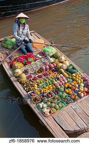 Vendor woman selling fruit Halong Bay Ha Long to boaters as they relax Vietnam View Large Photo Image Stock Photograph - Vendor woman selling fruit Halong Bay Ha Long to boaters as they relax Vietnam. Fotosearch