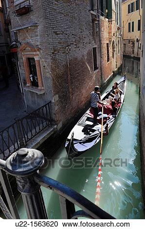 Stock Image - Venezia (Italy): gondola along a canal. Fotosearch
