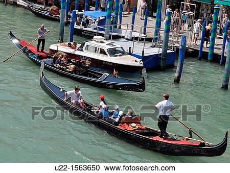 Stock Image - Venezia (Italy): gondole along a canal. Fotosearch