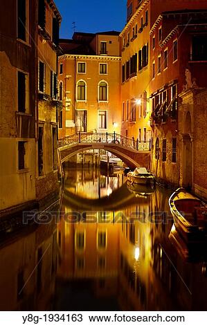 Stock Image - Venice by night - water street of Venice, pathbridge over the canal, Venice, Italy, UNESCO.. Fotosearch