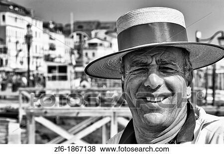 Stock Photo - Venice Venezia Italy gondola driver with red straw hat for tourists on Grand Canal. Fotosearch