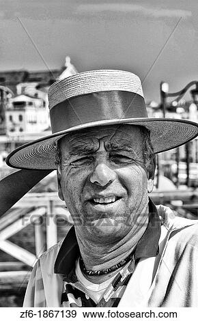 Stock Photo - Venice Venezia Italy gondola driver with red straw hat for tourists on Grand Canal. Fotosearch