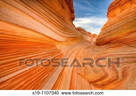 Vermilion Cliffs Wilderness Area of northern Arizona, USA. The area is called North Coyote Buttes, and this specific rock formation is called the wave". The rock is actually petrified sand dunes which has formed striated sandstone. " View Large Photo Image Stock Image - Vermilion Cliffs Wilderness Area of northern Arizona, USA. The area is called North Coyote Buttes, and this specific rock formation is called the wave". The rock is actually petrified sand dunes which has formed striated sandstone. ". Fotosearch