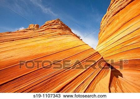 Vermilion Cliffs Wilderness Area of northern Arizona, USA. The area is called North Coyote Buttes, and this specific rock formation is called the wave". The rock is actually petrified sand dunes which has formed striated sandstone. " View Large Photo Image Stock Image - Vermilion Cliffs Wilderness Area of northern Arizona, USA. The area is called North Coyote Buttes, and this specific rock formation is called the wave". The rock is actually petrified sand dunes which has formed striated sandstone. ". Fotosearch