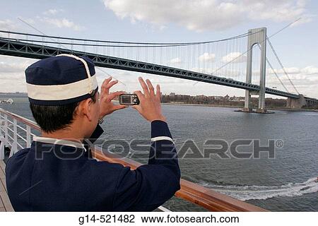 Verrazano Narrows Bridge, Holland America Line, MS Noordam, Asian male bellhop, camera. Lower New York Bay. New York. USA. View Large Photo Image Stock Image - Verrazano Narrows Bridge, Holland America Line, MS Noordam, Asian male bellhop, camera. Lower New York Bay. New York. USA.. Fotosearch