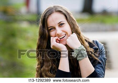 Very happy with finger in mouth young woman portrait View Large Photo Image Stock Photo - Very happy with finger in mouth young woman portrait. Fotosearch