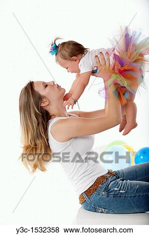 Very young mother with baby girl View Large Photo Image Stock Photo - Very young mother with baby girl. Fotosearch