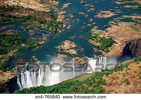 victoria falls from the air, waterfall of the zambezi river flowing from zambia to zimbabwe View Large Photo Image Stock Image - victoria falls from the air, waterfall of the zambezi river flowing from zambia to zimbabwe. Fotosearch