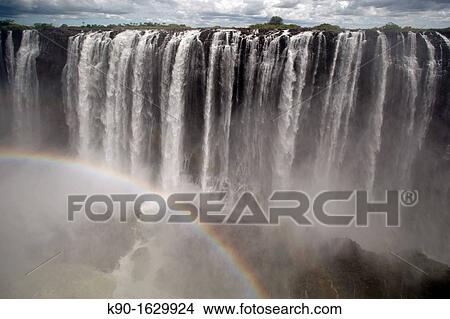 Victoria Falls with clouds and rainbow, Zimbabwe View Large Photo Image Picture - Victoria Falls with clouds and rainbow, Zimbabwe. Fotosearch