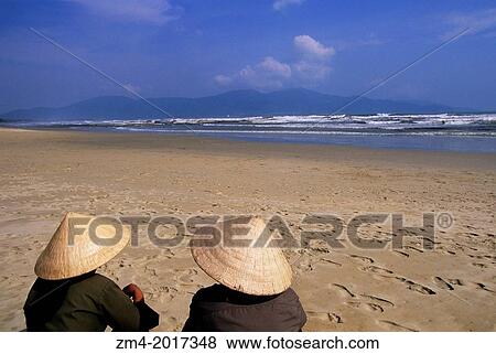VIETNAM, DANANG, FURAMA RESORT AT CHINA BEACH, BEACH, PEOPLE WITH TYPICAL VIETNAMESE HATS. View Large Photo Image Stock Photo - VIETNAM, DANANG, FURAMA RESORT AT CHINA BEACH, BEACH, PEOPLE WITH TYPICAL VIETNAMESE HATS.. Fotosearch