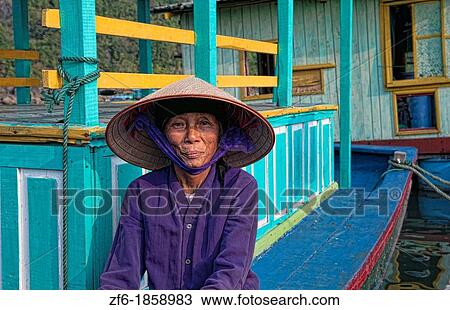 Vietnam, Halong Bay, Old woman in purple in fishing village View Large Photo Image Stock Image - Vietnam, Halong Bay, Old woman in purple in fishing village. Fotosearch