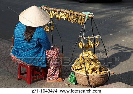 Picture - Vietnam, Ho Chi Minh City, Saigon, street snacks vendor. Fotosearch
