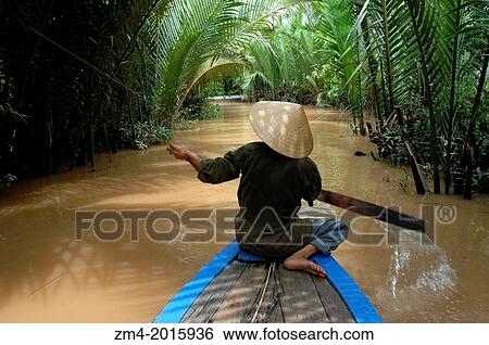 VIETNAM, NEAR SAIGON (HO CHI MINH CITY), MEKONG RIVER DELTA, WOMAN WITH CONE HATS (NON LA) IN BOAT. View Large Photo Image Stock Photograph - VIETNAM, NEAR SAIGON (HO CHI MINH CITY), MEKONG RIVER DELTA, WOMAN WITH CONE HATS (NON LA) IN BOAT.. Fotosearch