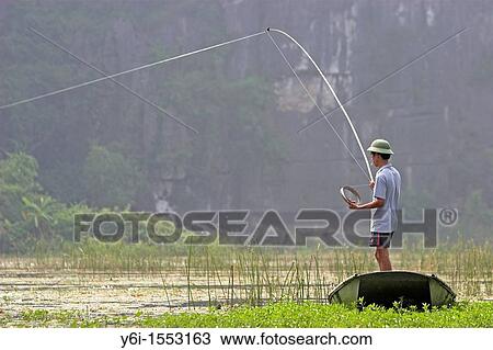 Vietnamese fisherman with rod and hand reel Ngo Dong River Tam Coc near Ninh Binh north Vietnam View Large Photo Image Stock Image - Vietnamese fisherman with rod and hand reel Ngo Dong River Tam Coc near Ninh Binh north Vietnam. Fotosearch
