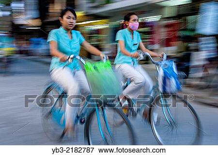 Vietnamese School Girls Cycling To School, Hoi An, Quang Nam Province, Vietnam. View Large Photo Image Stock Photo - Vietnamese School Girls Cycling To School, Hoi An, Quang Nam Province, Vietnam.. Fotosearch