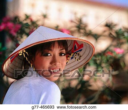 Stock Image - Vietnamese woman in traditional dress, Ho Chi Minh City. Vietnam. Fotosearch