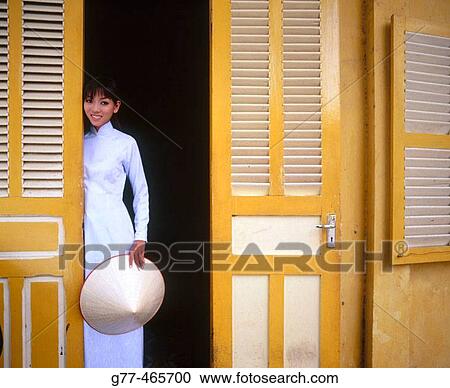 Stock Image - Vietnamese woman in traditional dress, Ho Chi Minh City. Vietnam. Fotosearch